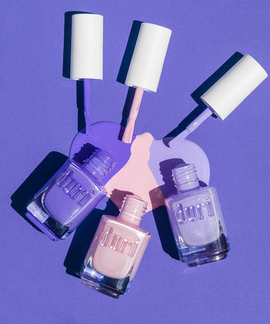 Light pink nail polish, light purple nail polish, and true purple nail polish set. 